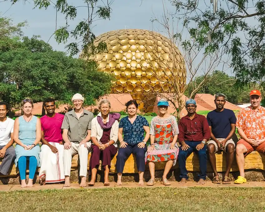 Auroville International USA (AVI USA) group with Matthew Andrews seated in front of the Matrimandir in Auroville, India