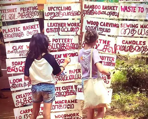 two girls looking at Tamil posters