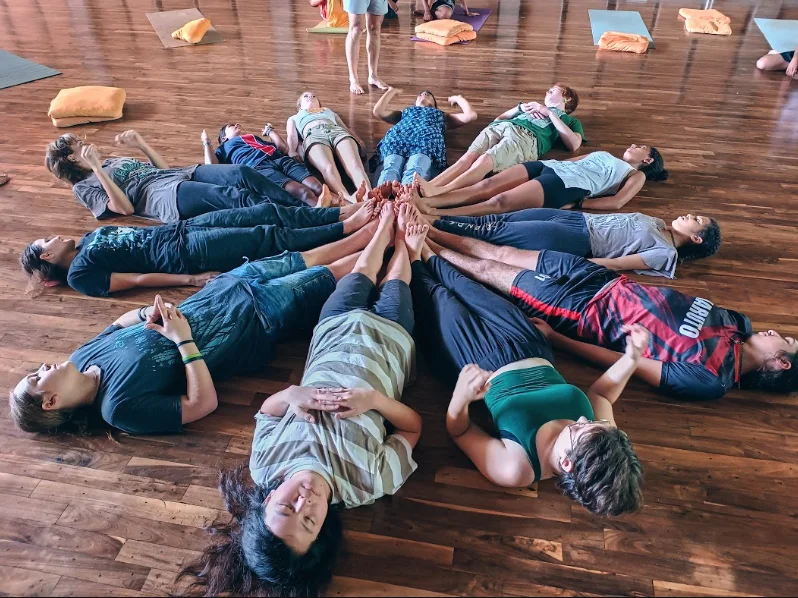 Students lying in a circle during a performing arts activity