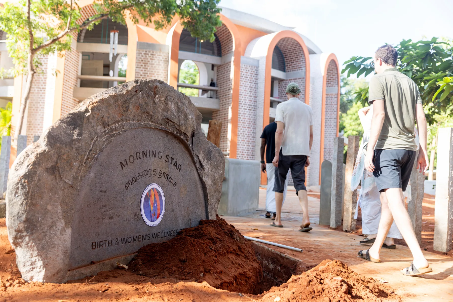 A carved stone sign reading Morning Star, Birth and Women's Wellness, in English and Tamil
