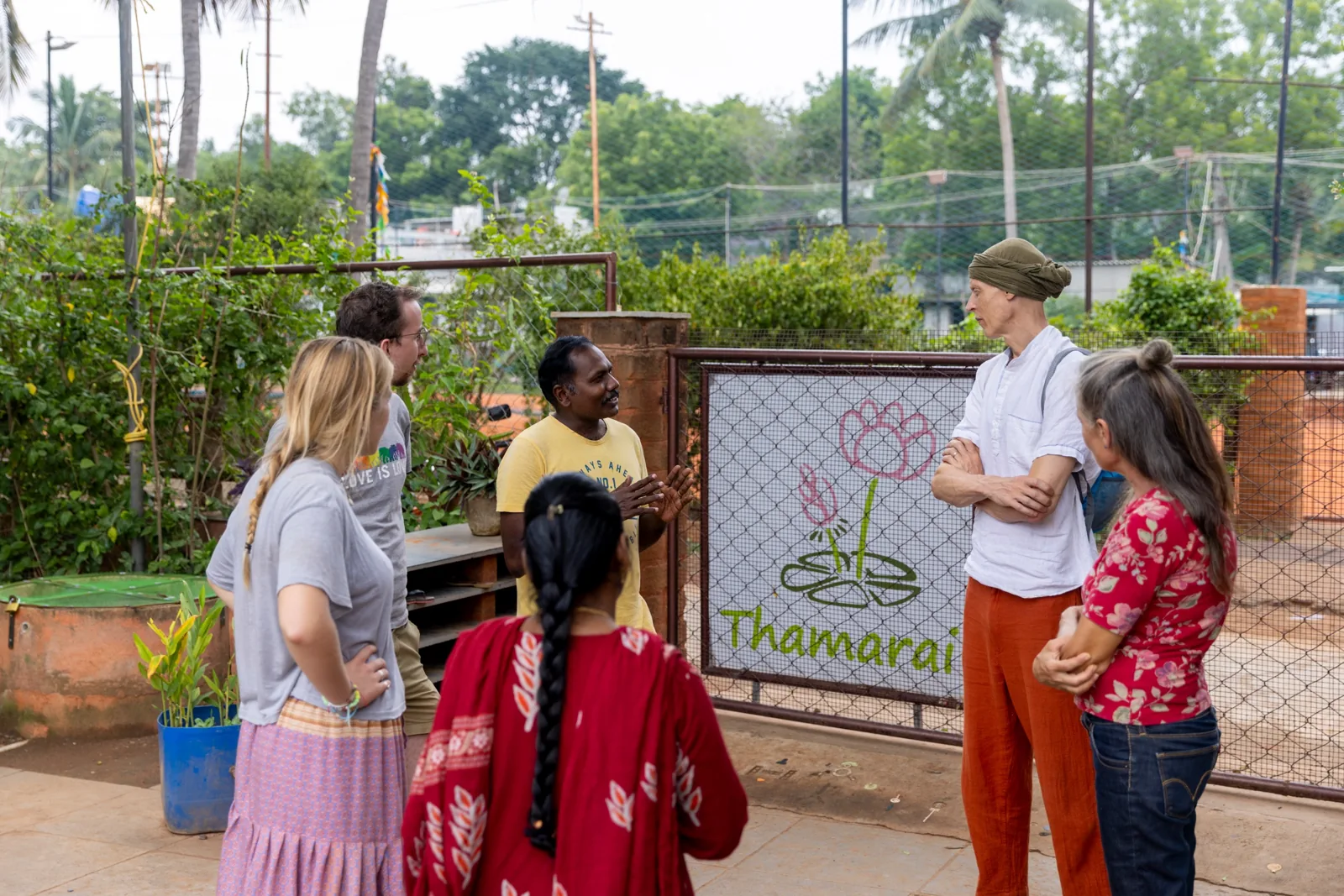 Visitors listening to a partner at the Thamarai gate