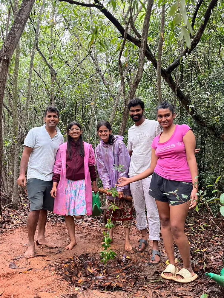 Nevish with the team after planting a sapling