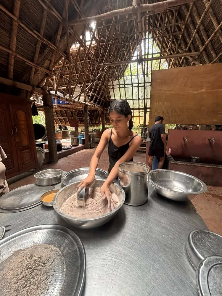 Nevish preparing food in the Sadhana Forest kitchen
