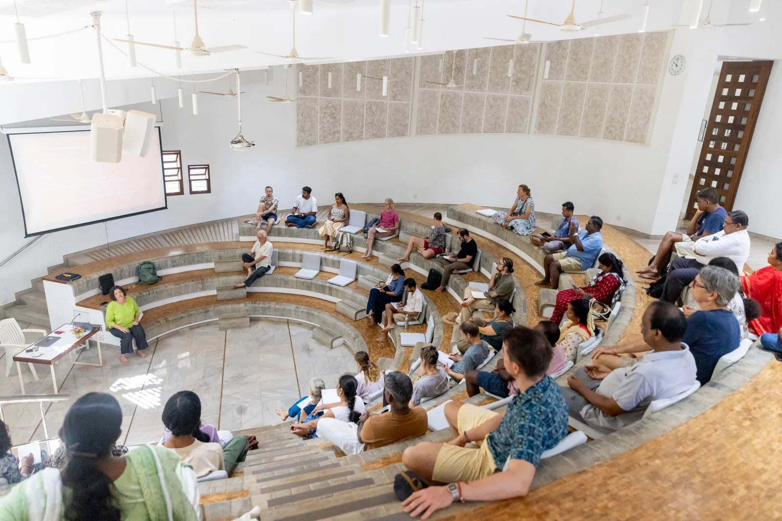 About 40 partner representatives seated in the round hall at Savitri Bhavan